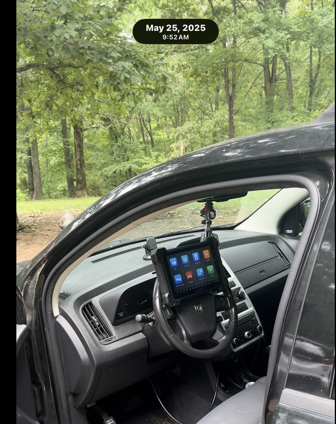 Autel diagnostic tablet mounted on a Dodge steering wheel during a key programming job