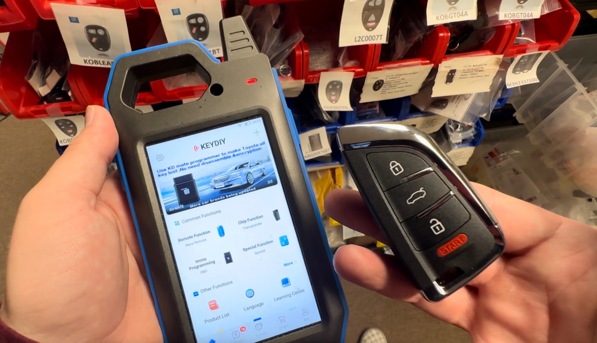 KEYDIY key programmer and smart remote in a locksmith's hands